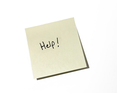Sticky note with the word HELP written on it.